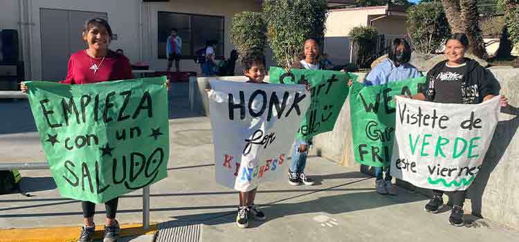 Students standing with posterboard signs